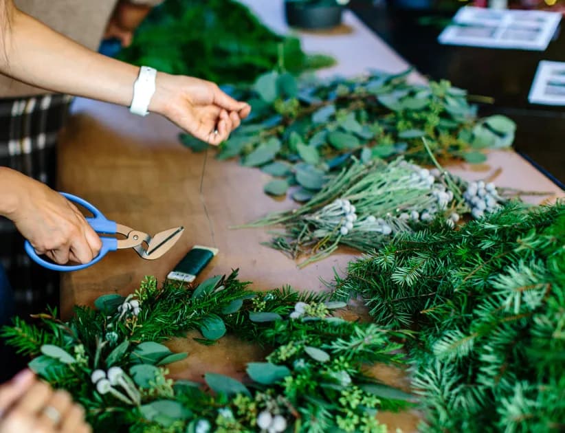 Fresh greenery being arranged for an event